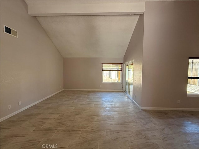 interior space featuring high vaulted ceiling, visible vents, beamed ceiling, and baseboards