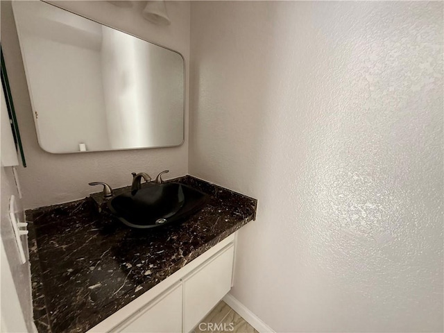 bathroom with vanity and baseboards