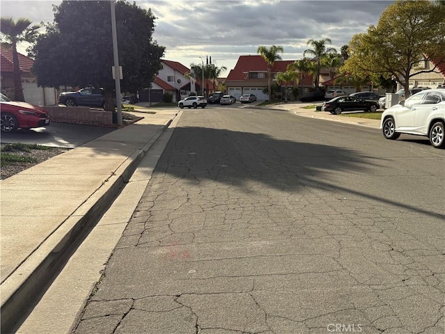 view of street featuring sidewalks, a residential view, and curbs