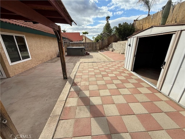 view of patio / terrace featuring a fenced backyard and a hot tub