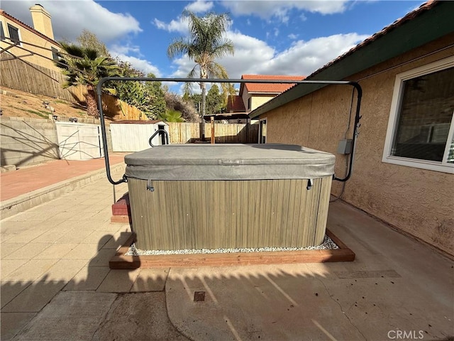 view of patio / terrace featuring a fenced backyard and a hot tub