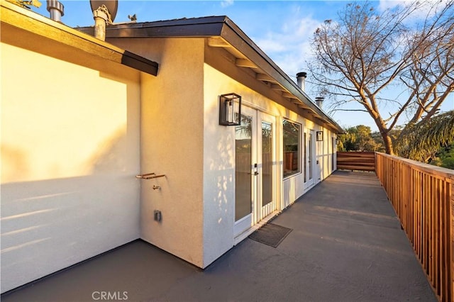 view of side of home with stucco siding