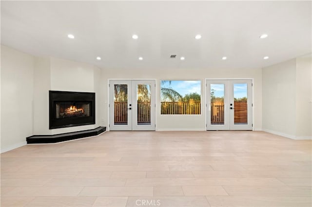 interior space with recessed lighting, french doors, and baseboards