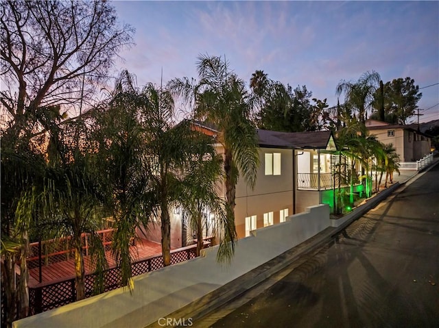 view of front of home with fence and stucco siding