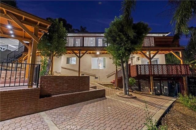 back of house at twilight with stucco siding