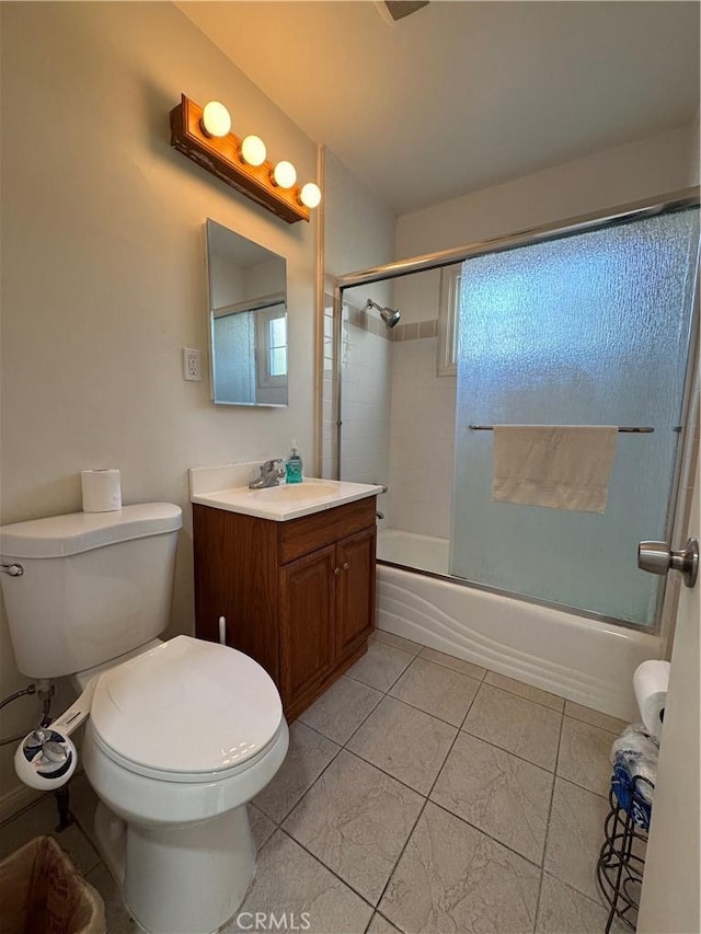 full bathroom with enclosed tub / shower combo, vanity, and toilet