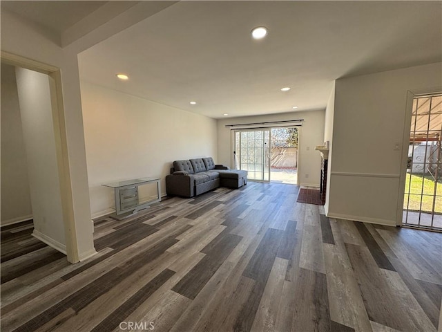 unfurnished room featuring dark wood-style floors, recessed lighting, and baseboards