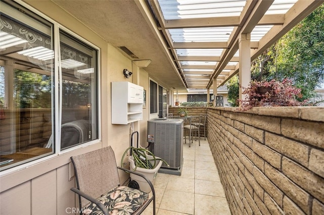 view of patio / terrace featuring central AC unit, a pergola, and outdoor dining space