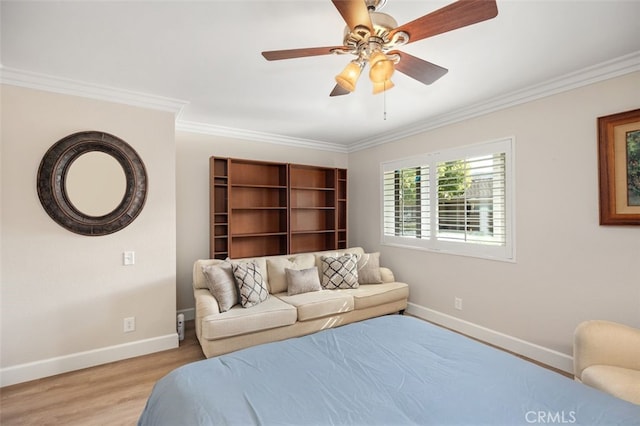 bedroom with baseboards, light wood-type flooring, a ceiling fan, and crown molding