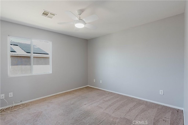 empty room with baseboards, carpet, visible vents, and a ceiling fan