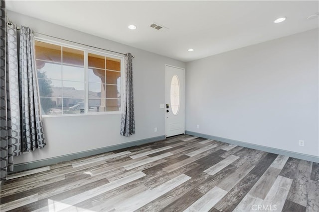 interior space with recessed lighting, wood finished floors, visible vents, and baseboards