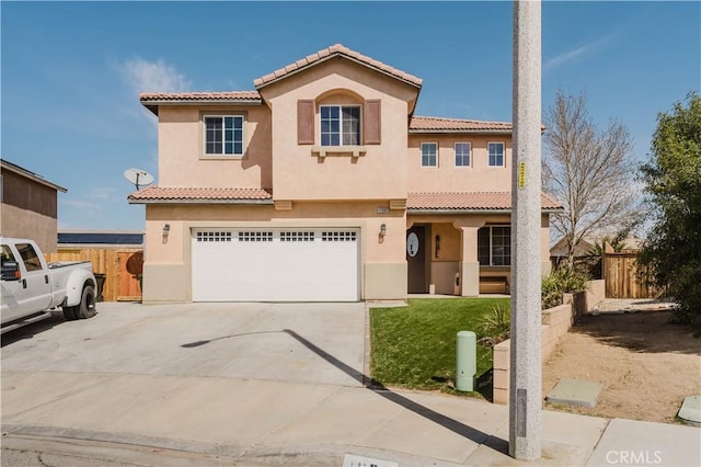 mediterranean / spanish house featuring a tile roof, stucco siding, fence, a garage, and driveway