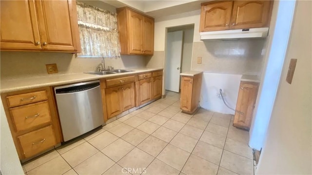 kitchen with light countertops, dishwasher, under cabinet range hood, and a sink