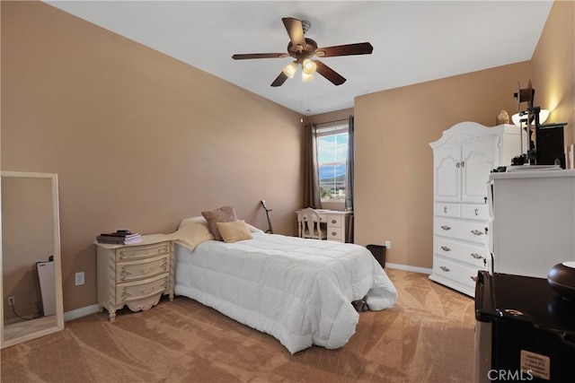 bedroom featuring light carpet, ceiling fan, and baseboards