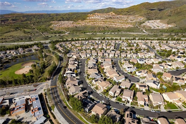 drone / aerial view with a residential view and a water and mountain view