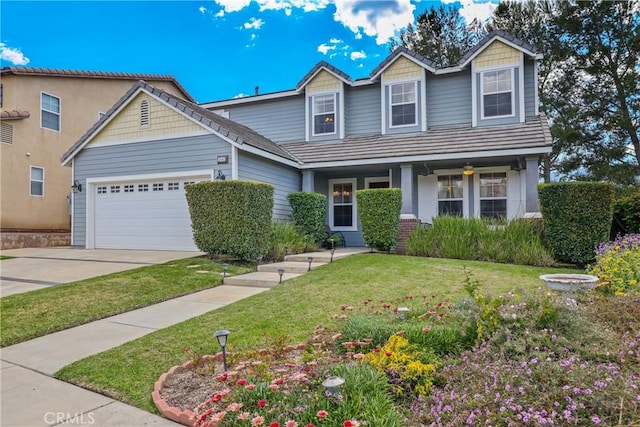 craftsman-style house featuring a garage, driveway, and a front lawn