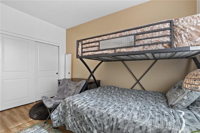 bedroom with a closet and wood finished floors