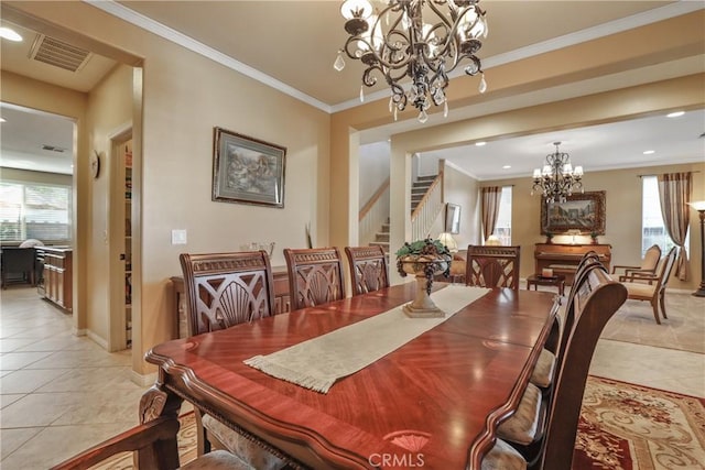 dining area with crown molding, light tile patterned flooring, visible vents, and an inviting chandelier