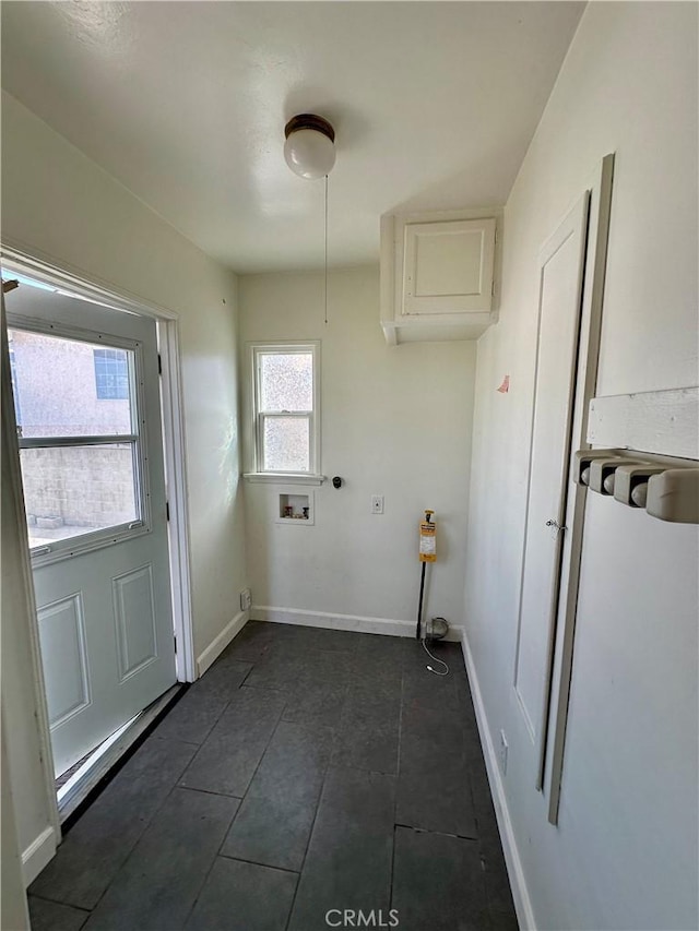 clothes washing area with laundry area, washer hookup, and baseboards