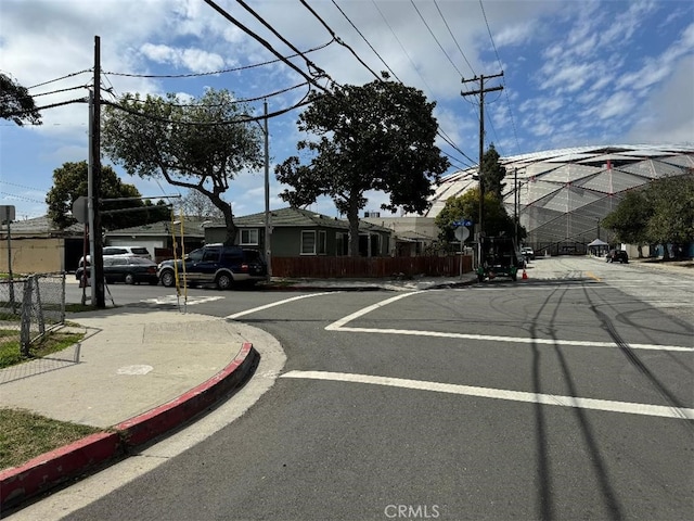 view of street featuring traffic signs and curbs