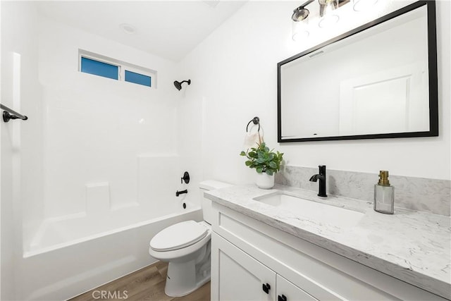 bathroom featuring visible vents, toilet, wood finished floors,  shower combination, and vanity