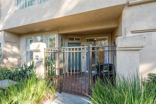 view of exterior entry featuring stucco siding