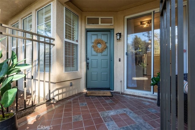 property entrance with stucco siding