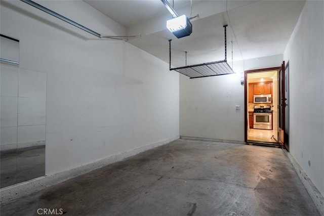 garage with a garage door opener and baseboards