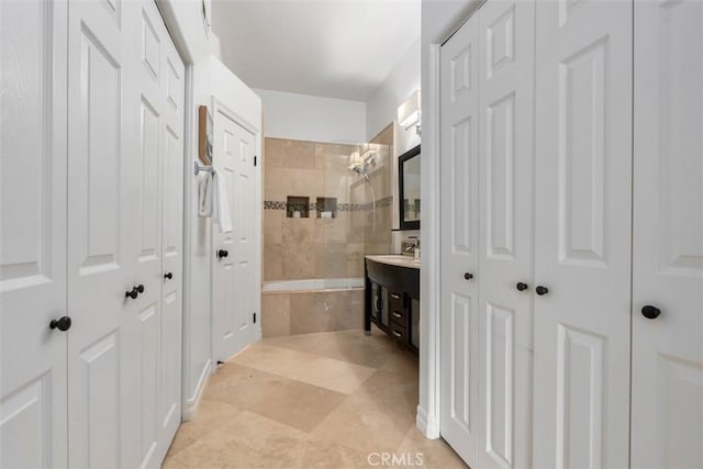 full bath featuring a closet, vanity, and tiled shower / bath