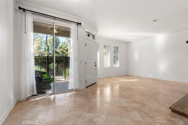 foyer with crown molding and baseboards