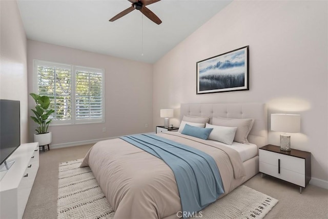 bedroom featuring light colored carpet, baseboards, lofted ceiling, and ceiling fan