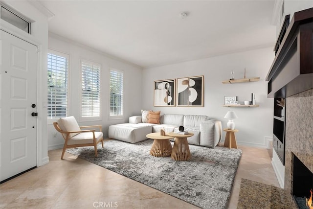 living room featuring baseboards and ornamental molding