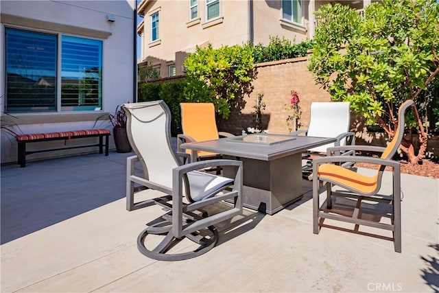 view of patio with outdoor dining space and fence