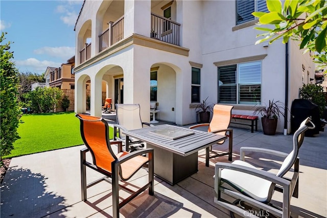 view of patio featuring a balcony