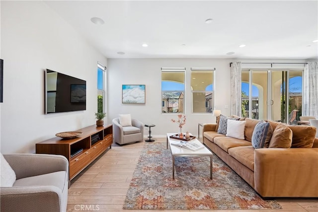 living room with recessed lighting and light wood-style floors