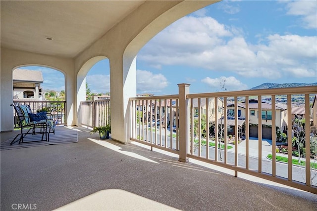 balcony featuring a residential view and a mountain view