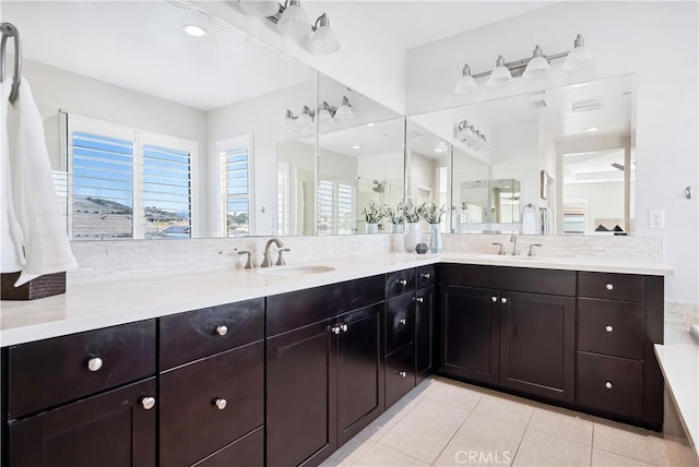 full bathroom featuring double vanity, tile patterned flooring, and a sink