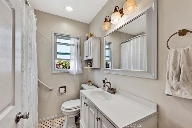 full bathroom with toilet, baseboards, and vanity