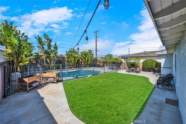 view of yard featuring fence private yard, a patio area, and a fenced in pool