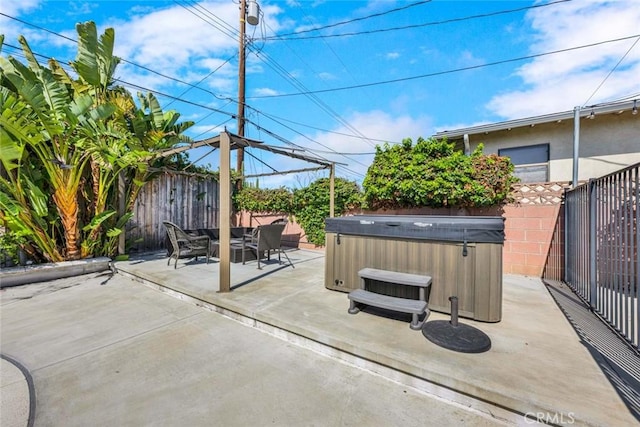 view of patio with a hot tub and a fenced backyard