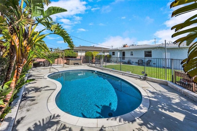 view of pool with a hot tub, a fenced in pool, fence, a yard, and a patio area