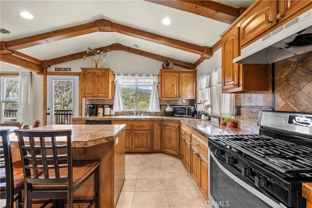 820 Arbula Dr, Crestline, CA 92325 - kitchen featuring lofted ceiling with beams, a center island, under cabinet range hood, and appliances with stainless steel finishes