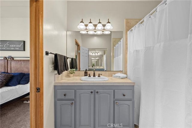 bathroom with vanity and ensuite bathroom