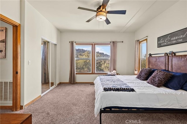 bedroom featuring ceiling fan, carpet, visible vents, and baseboards