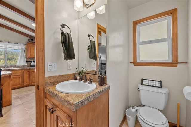 bathroom with toilet, tile patterned floors, lofted ceiling with beams, and vanity