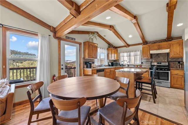 dining area featuring lofted ceiling with beams, recessed lighting, baseboards, and light wood-style floors