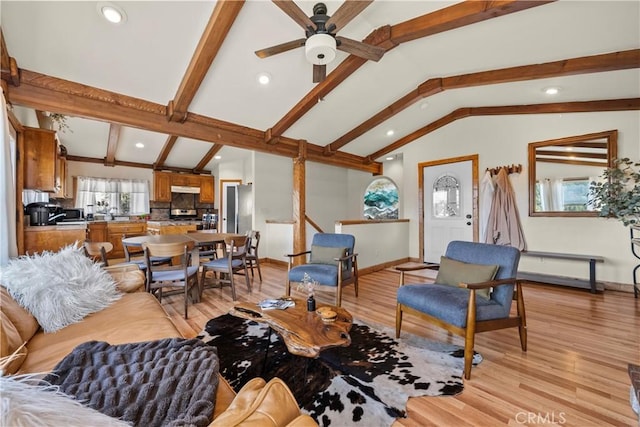 living area with recessed lighting, lofted ceiling with beams, a ceiling fan, light wood-type flooring, and baseboards