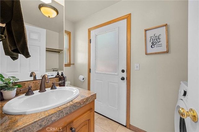 bathroom with washer / clothes dryer, vanity, and tile patterned floors