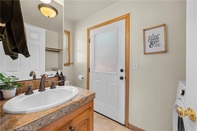 820 Arbula Dr, Crestline, CA 92325 - bathroom with vanity, washer / dryer, tile patterned flooring, and baseboards