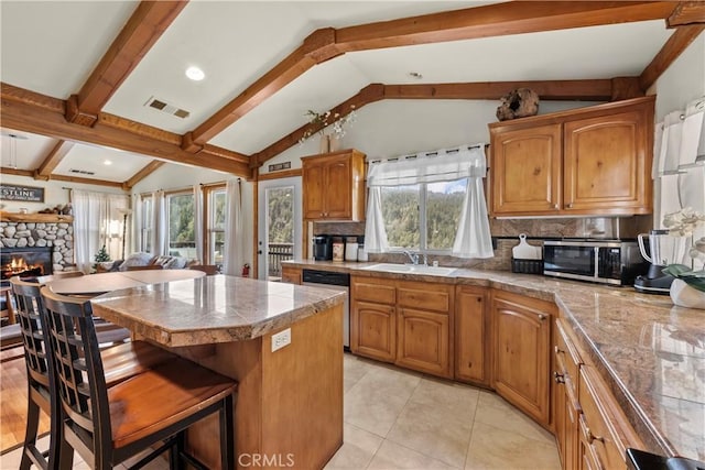 820 Arbula Dr, Crestline, CA 92325 - kitchen featuring decorative backsplash, vaulted ceiling with beams, a fireplace, appliances with stainless steel finishes, and visible vents